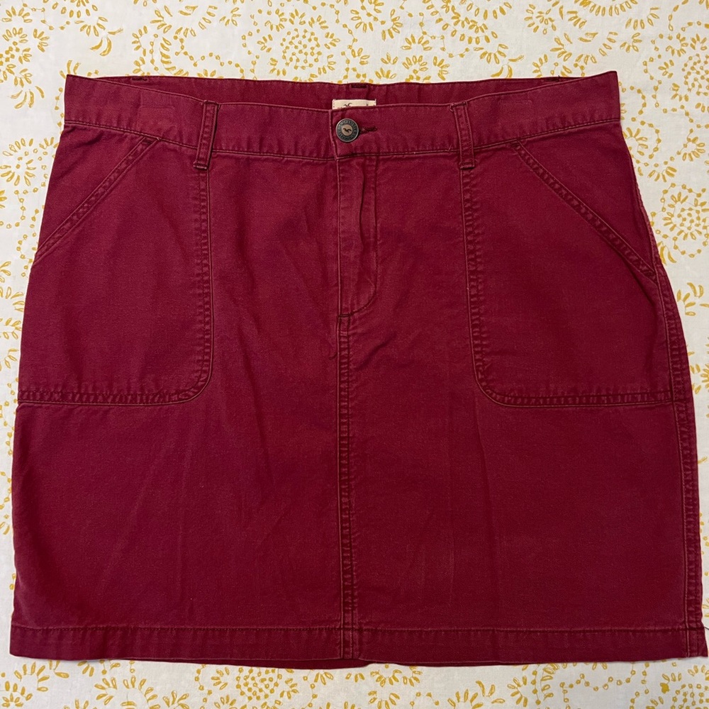 HOLLISTER Mini Skirt | Color : Cherry | Size : M | Bags in front of the skirt.